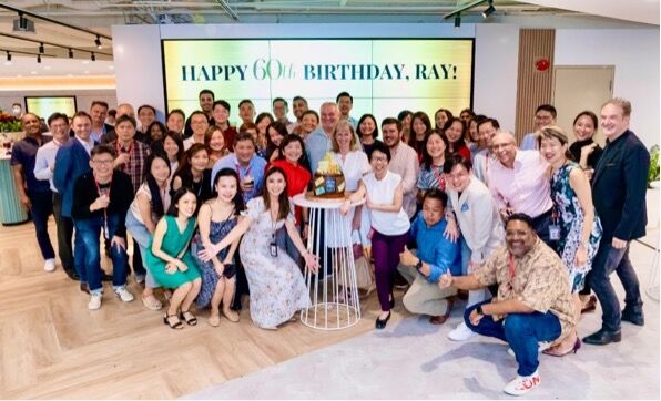 Ray Ferguson with Singlife colleagues at a surprise party for his 60th birthday, SGX Centre, 2023